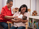 Woman Holding Baby in Rocking Chair