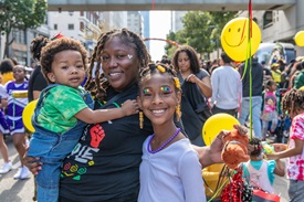 mom with toddler and child at community event