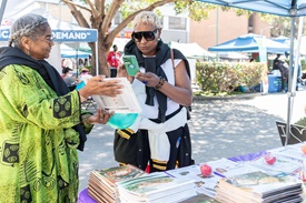 woman sharing event materials at a community event