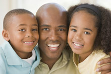 African-America father with young son and daughter