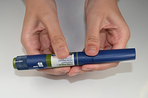 hand checking glucose levels on hand-held device
