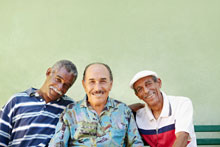 three senior men smiling