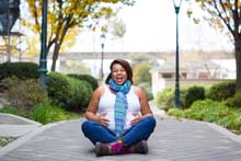 woman sitting on sidewalk